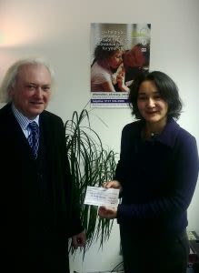 Jim McGuire presenting his donation to Sophie Pilgrim, Kindred's Director, in 2013.